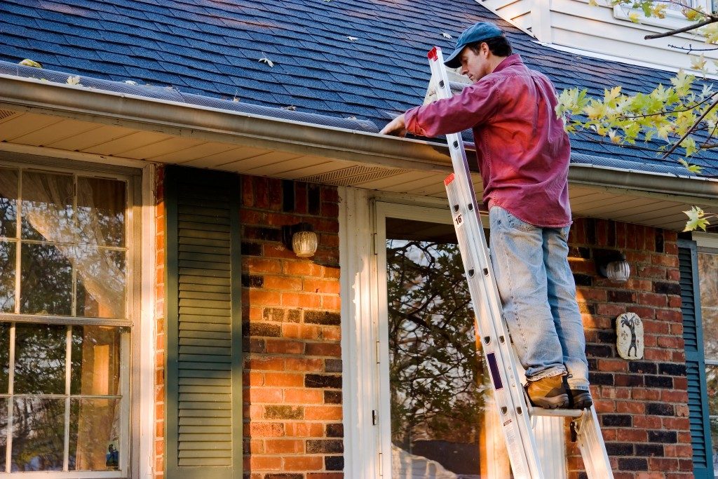 Man cleaning the gutter