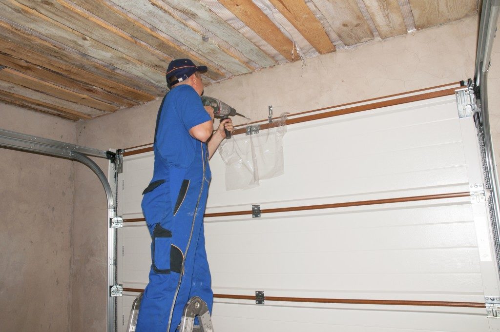 professional installing garage door