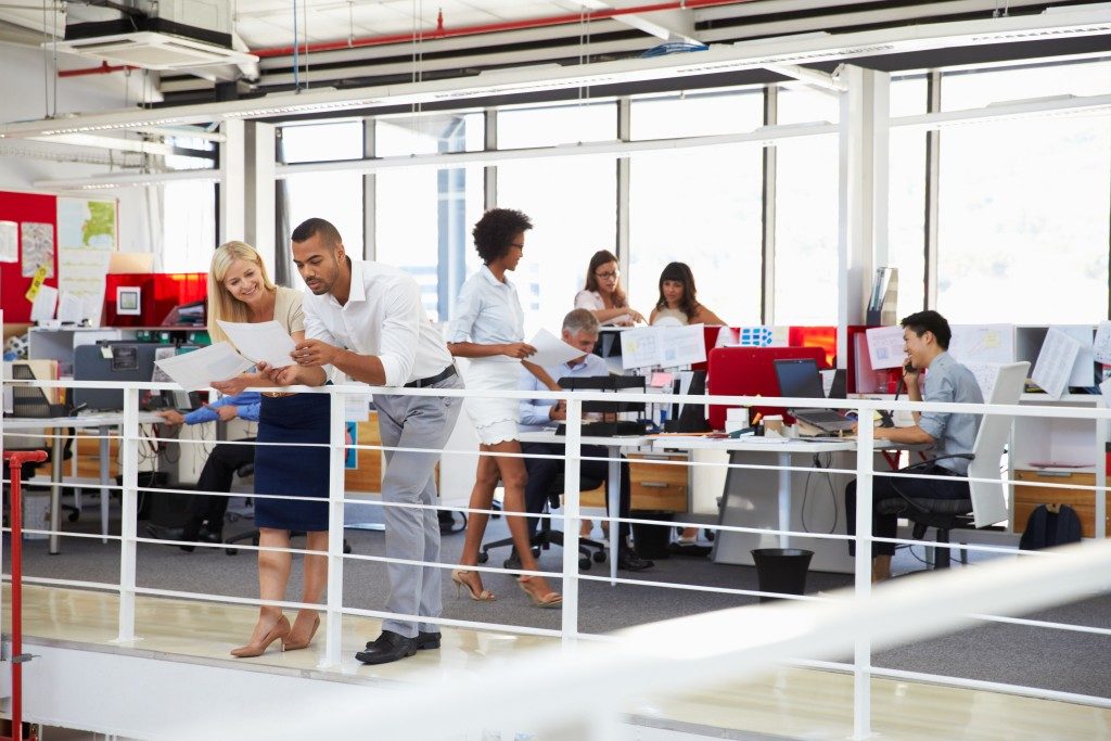 Staff working in a busy office mezzanine