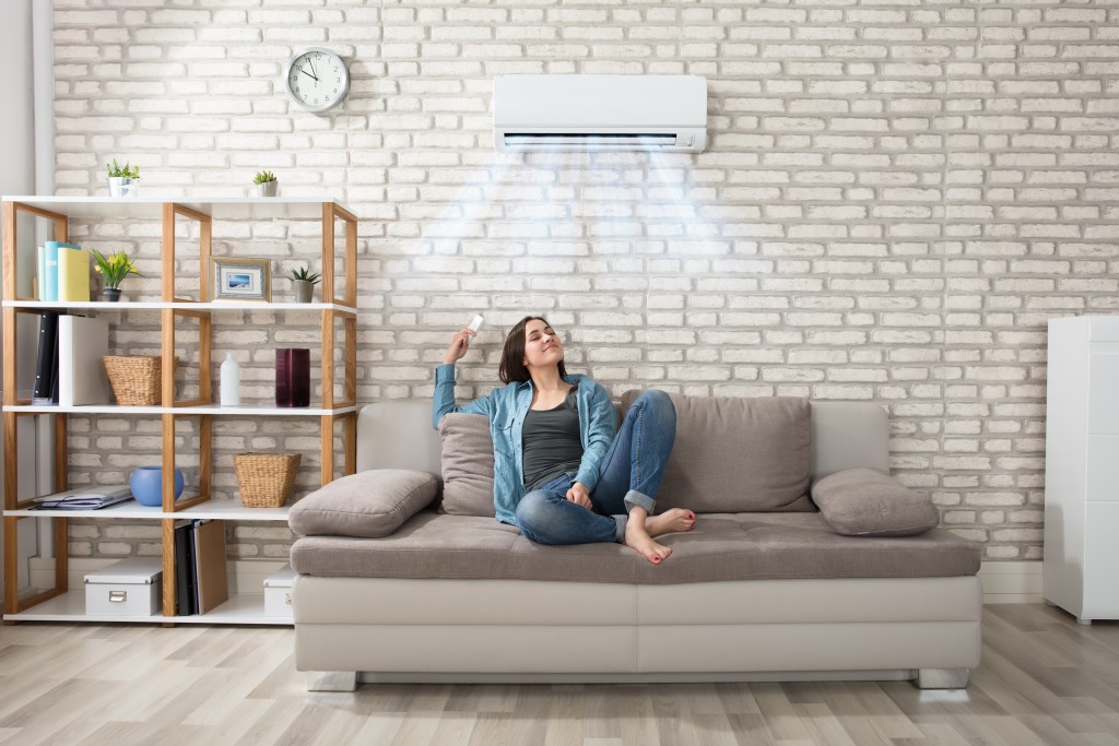 woman sitting in her living room with aircon