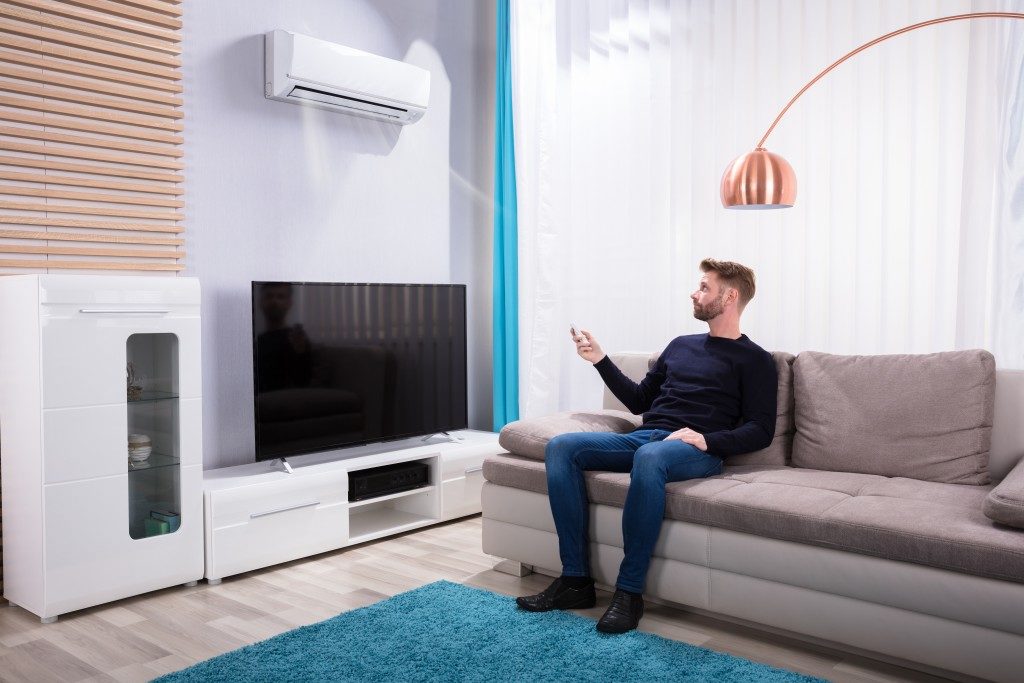 man in the living room using the ac