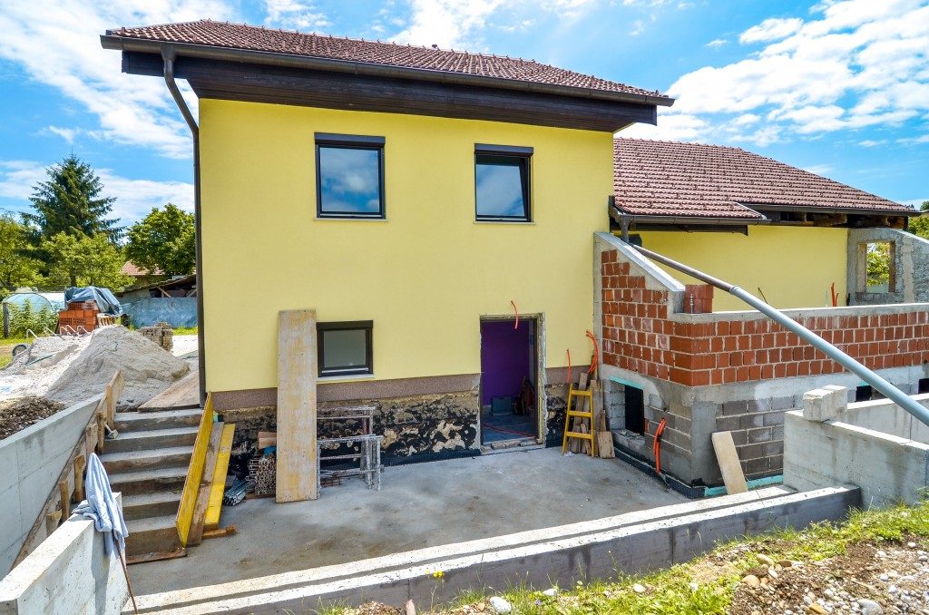 Rebuilding a family house and adding an extension. Setting up a construction site with formwork..