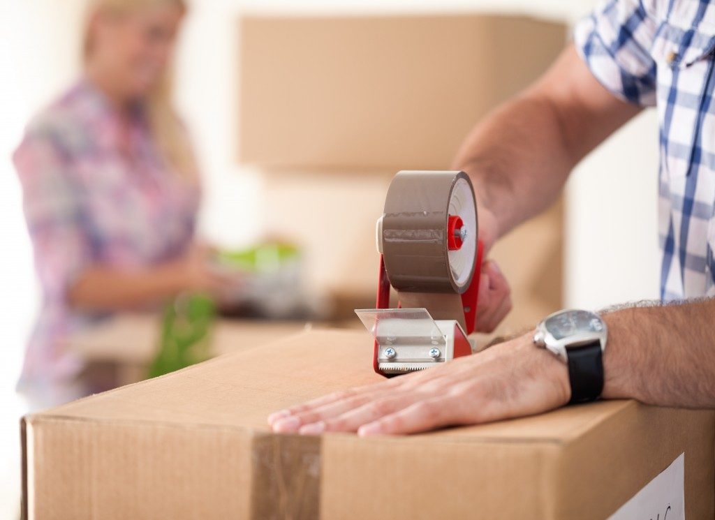 Close up of male hand packing a box