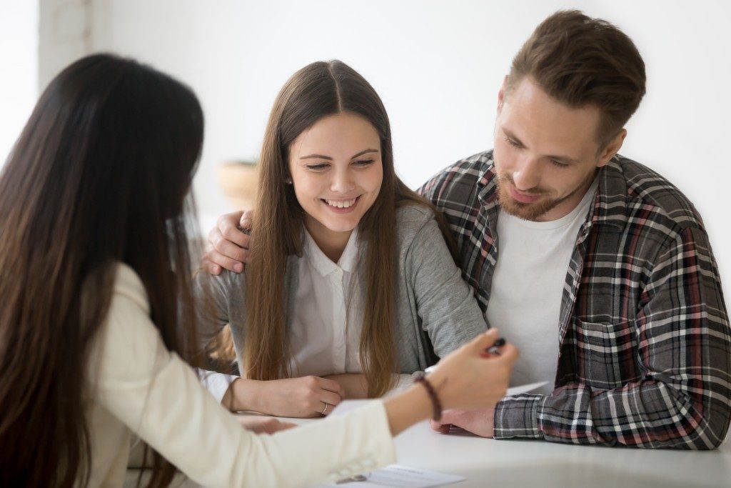 Couples looking at documents being explained