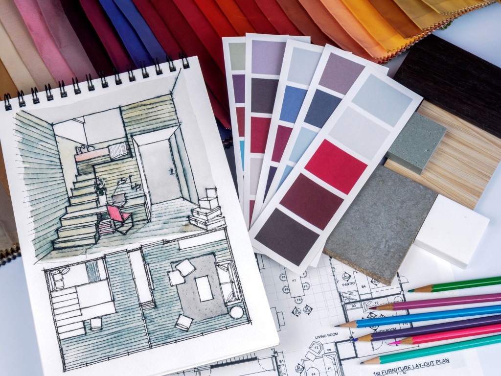 colored sketch of home design surroundby swatches and color pencils