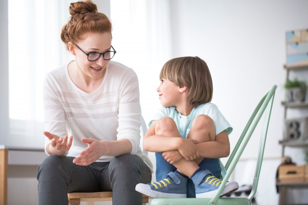 Little boy talking to a woman