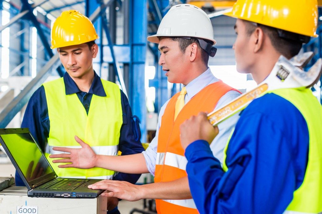 workers in gear talking in the workplace