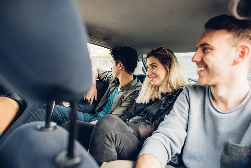 friends in the backseat of a car