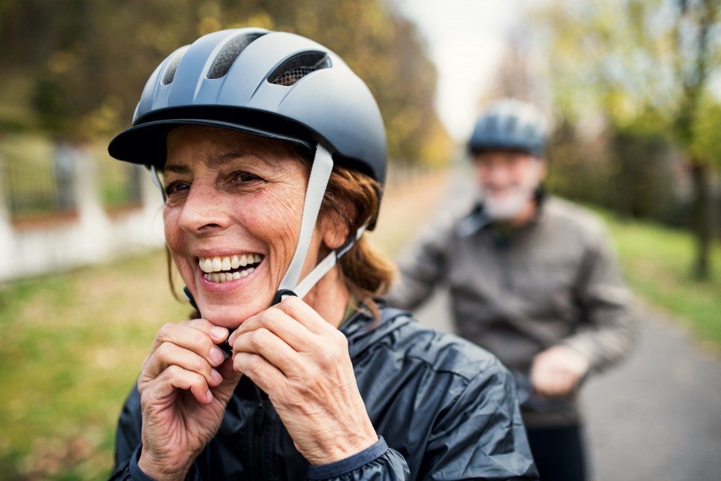 elder couple riding a bike