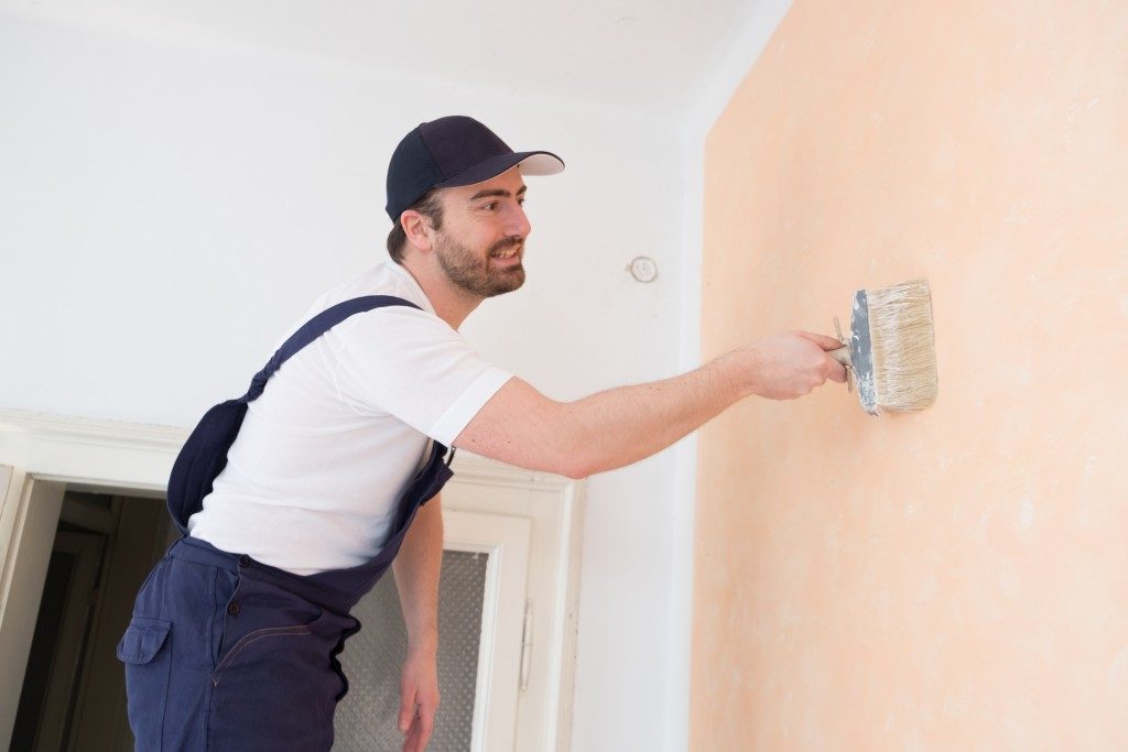 man painting the home wall