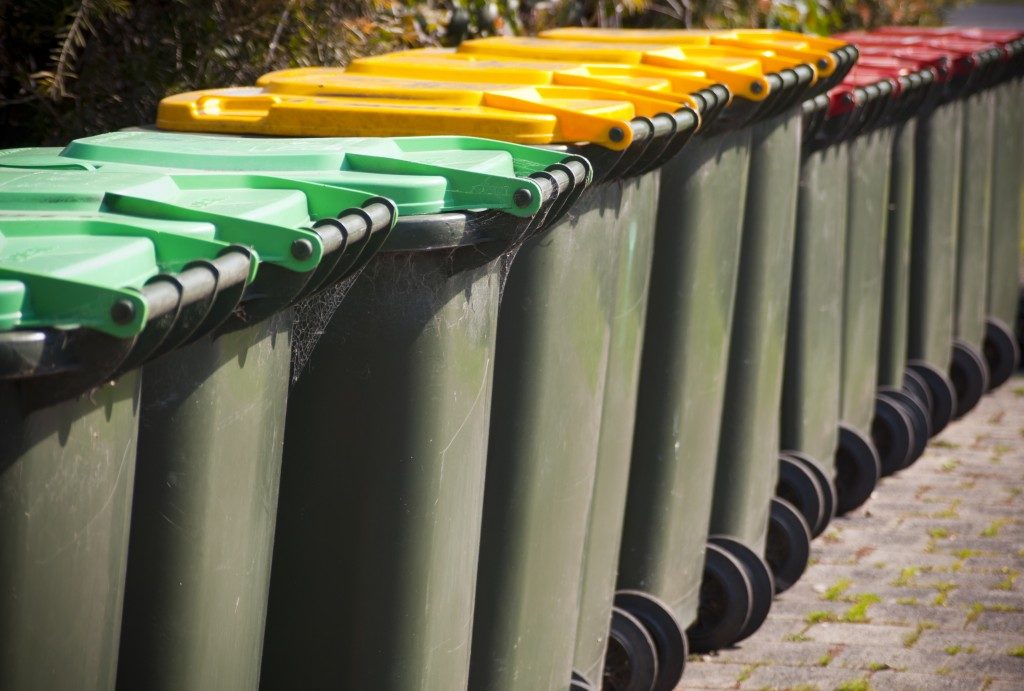 Trash bins with different colored covers