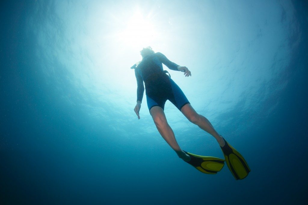 Free diver ascending to the surface