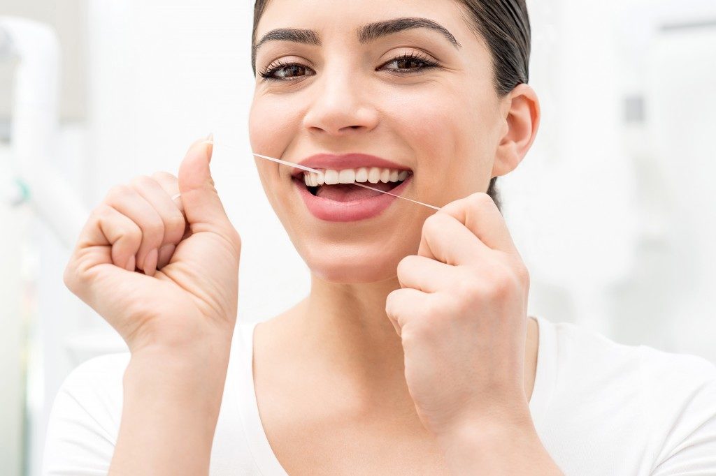 Woman flossing