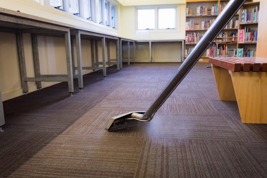 person vacuuming the floor