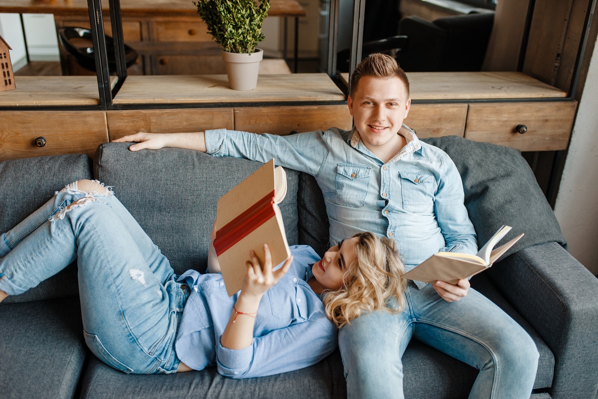 Love couple resting on comfortable couch at home