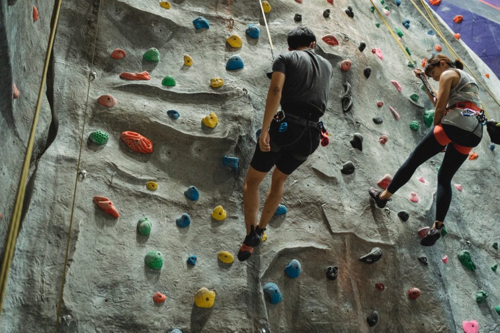 people climbing a wall