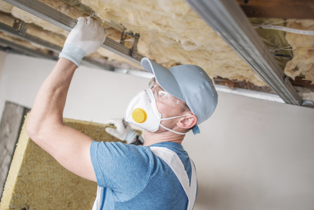 man installing insulation foam