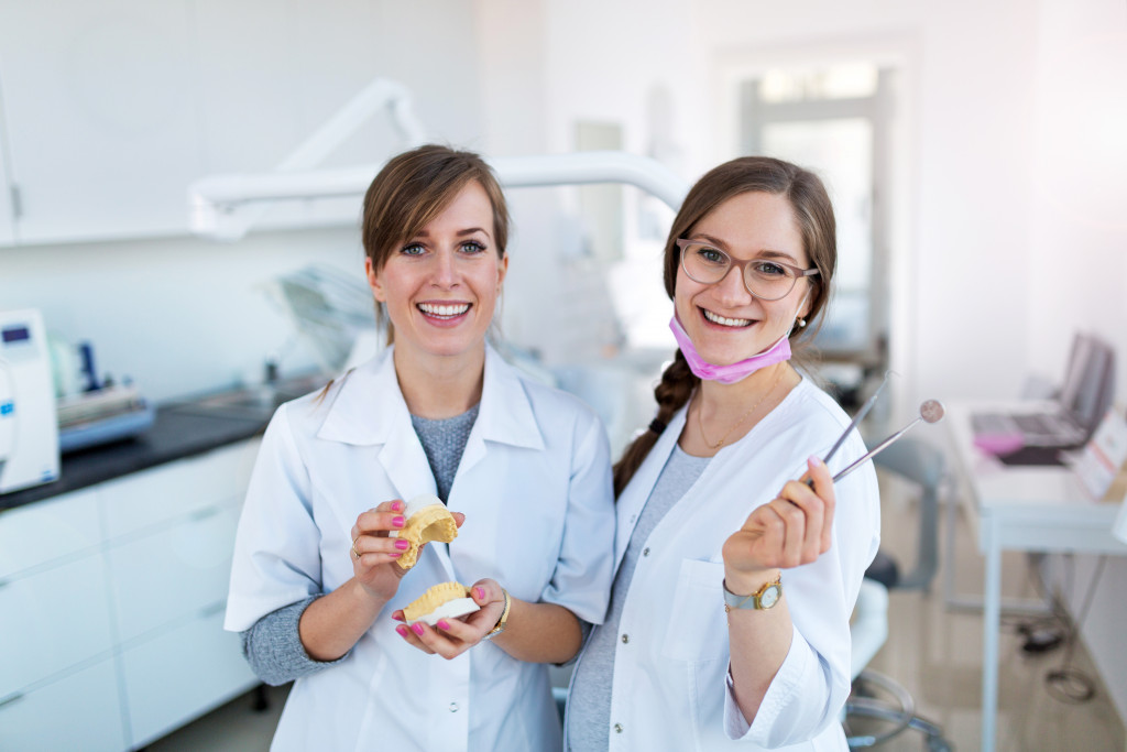 2 dentist wearing their uniform in a dental clinic