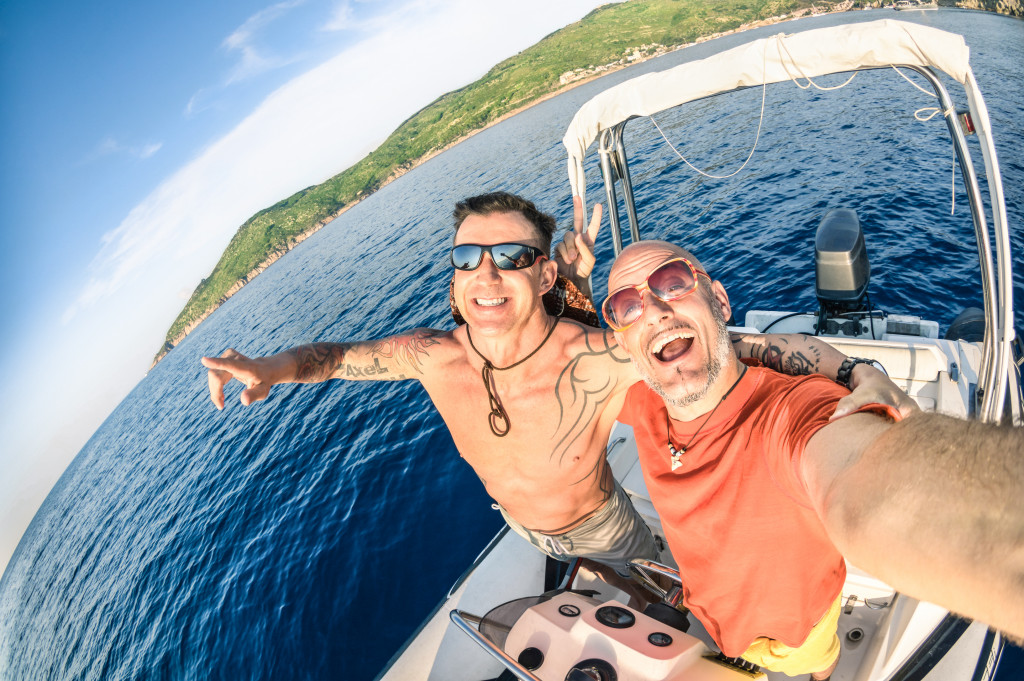Two guys taking a selfie on a speedboat