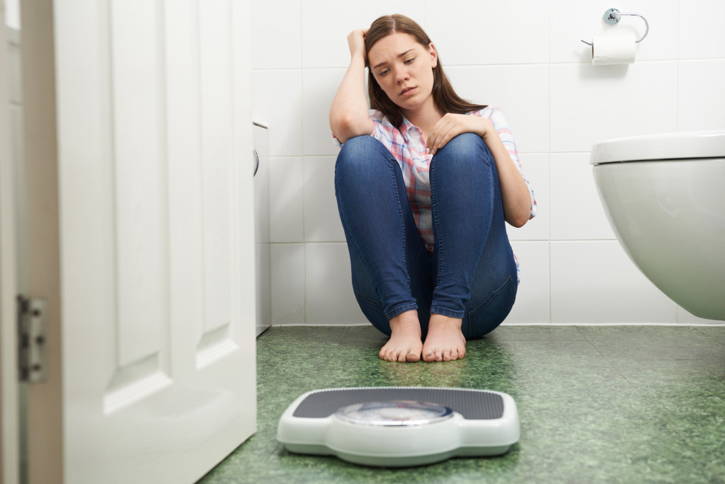 A person with eating disorder scared of weight tracking