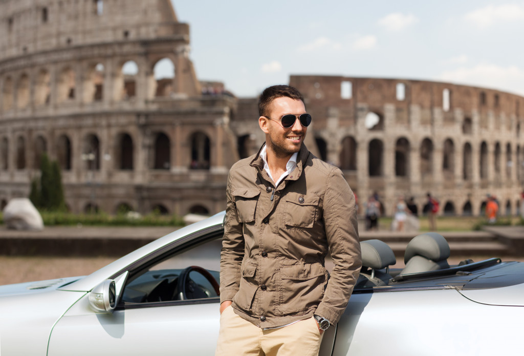 young man with sports car posing in Rome